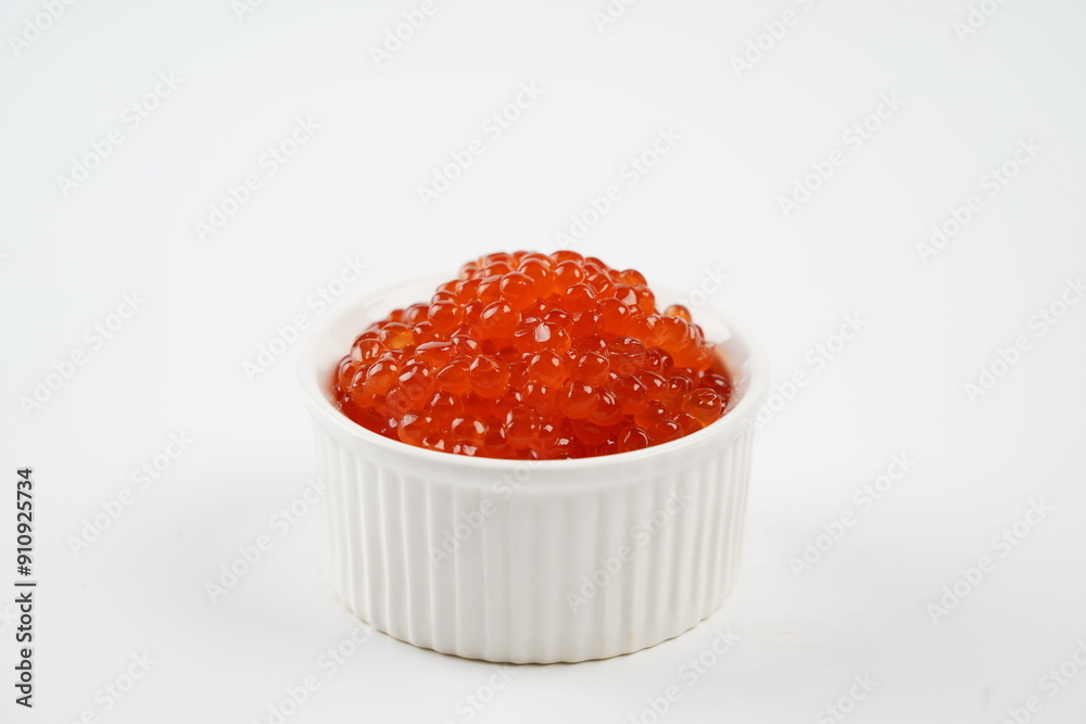 Salmon Red Caviar. Red fish caviar in white bowl. Raw seafood. Luxury delicacy food. White background. Salmon Red Caviar. Red fish caviar in white bowl. Raw seafood. Luxury delicacy food. White background.