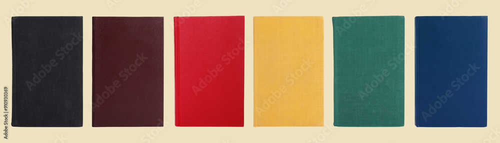 Many books with colorful hardcovers on beige background, set Many books with colorful hardcovers on beige background, set