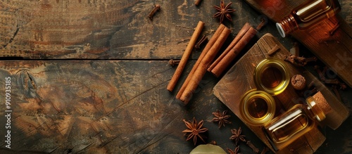 A wooden background with cinnamon sticks and aromatic essential oil for aromatherapy and organic cosmetics creating a spa concept with a designated copy space image included photo