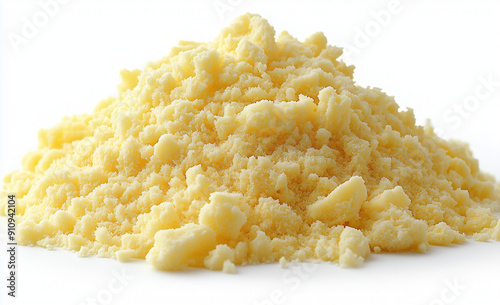 light yellow powder on a white background, with some small pieces scattered around the pile. The powder is not uniform in size and shape