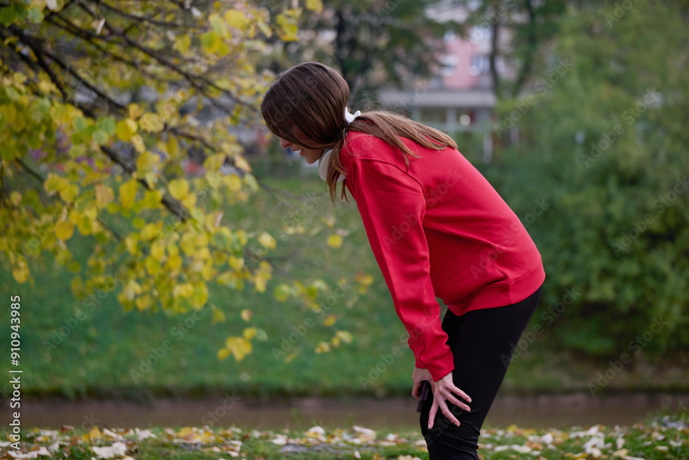 Athletic young woman taking a breath and relaxing after jogging and stretching. Woman Training and Workout Exercises On Street. Athletic young woman taking a breath and relaxing after jogging and stretching. Woman Training and Workout Exercises On Street.
