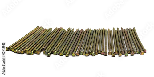 Golden sharp thin metal nails laid in one row on white background, closeup macro