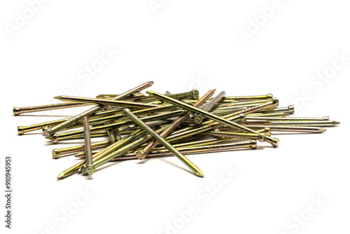 Pile of golden sharp thin metal nails scattered on white background, closeup macro