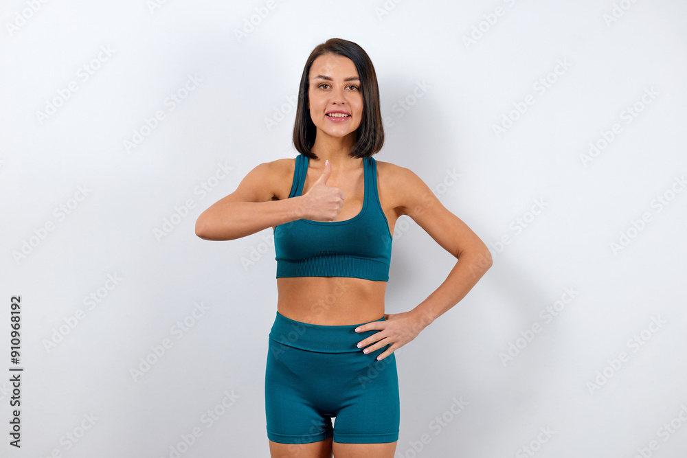 Portrait of a fitness trainer woman dressed in a stylish suit of shorts and top Portrait of a fitness trainer woman dressed in a stylish suit of shorts and top
