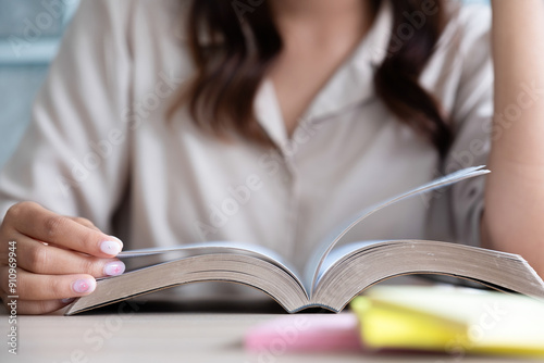 Young woman reading a book with music.