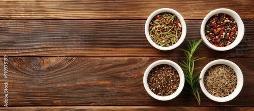 Top view of spices in small white bowls on a brown wooden backdrop suitable for pilaf ingredients with a vacant area for text like a copy space image photo