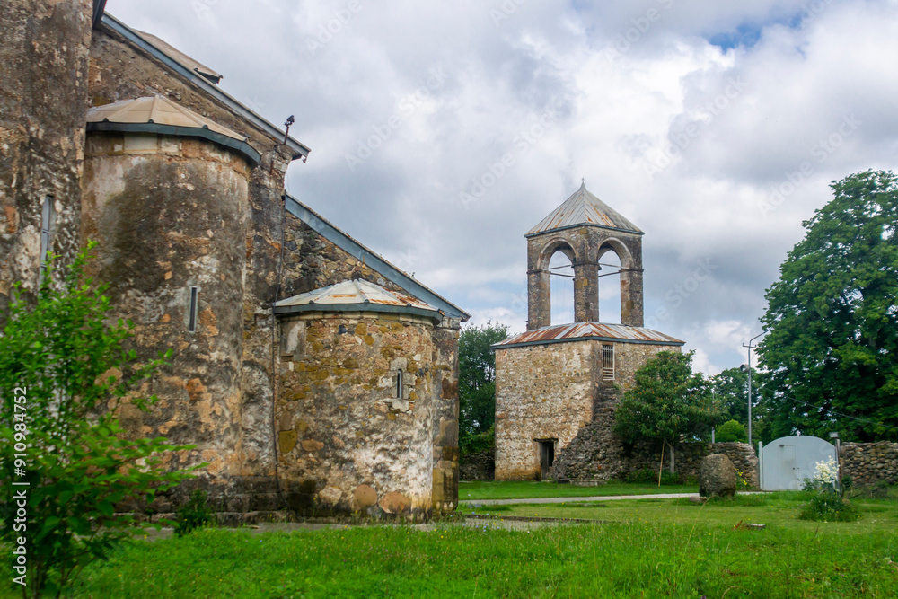 The Tsalenjikha Cathedral Church of the Transfiguration of Savior. Bell tower, courtyard with grass The Tsalenjikha Cathedral Church of the Transfiguration of Savior. Bell tower, courtyard with grass