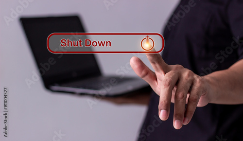 Young man hand touching laptop Shut Down button press power OFF