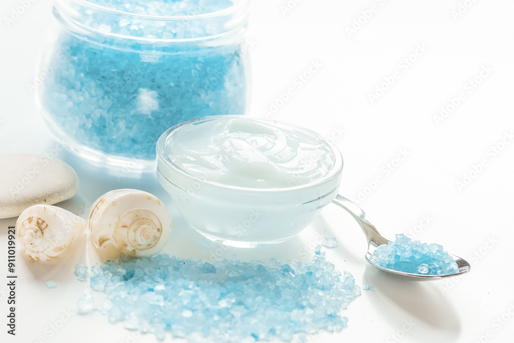 blue set for bath with salt and shells on white table background blue set for bath with salt and shells on white table background