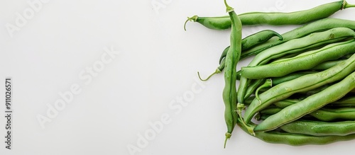 Green beans arranged neatly on a white backdrop, with a space for text or graphics included in the image. image with copy space photo