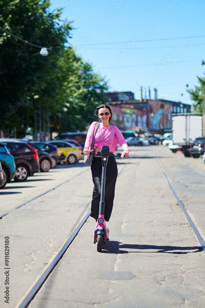 Mobile transport concept, young woman enjoying a ride on an electric scooter Mobile transport concept, young woman enjoying a ride on an electric scooter