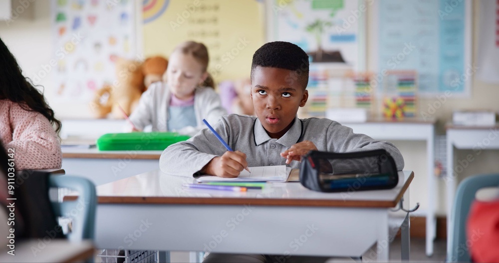 Boy, child and writing notes in classroom for learning, knowledge and info for assessment. Kid, notebook and education with scholarship, studying and attention at lesson for development at school Boy, child and writing notes in classroom for learning, knowledge and info for assessment. Kid, notebook and education with scholarship, studying and attention at lesson for development at school