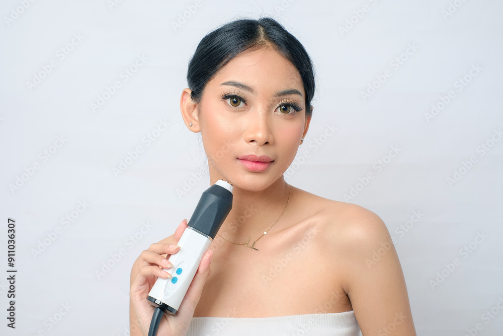 Beautiful Asian Woman with Bun Undergoing RF Ultrasound Oxygeneo Treatment on White Background Beautiful Asian Woman with Bun Undergoing RF Ultrasound Oxygeneo Treatment on White Background