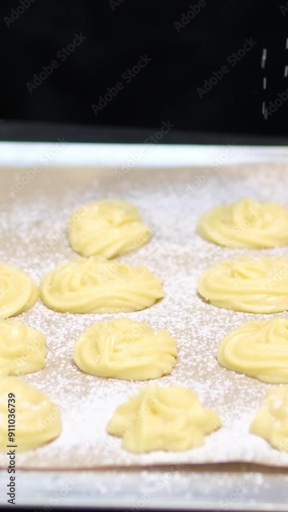 bake profiteroles pastry chef makes eclairs in a bakery. eclairs are baked in the oven. eclair production process. pastry bag with dough bake profiteroles pastry chef makes eclairs in a bakery. eclairs are baked in the oven. eclair production process. pastry bag with dough