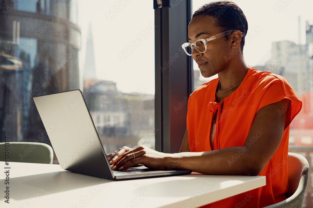 © Westend61 - Focused businesswoman working on laptop at desk in office © Westend61 - Focused businesswoman working on laptop at desk in office