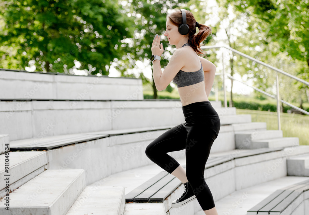 Obraz premium Young Girl Exercises By Running Up And Down Stairs Outdoors