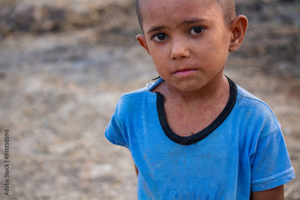 Photography Portrait of a Young Boy in Blue Shirt Expressing Innocence and Vulnerability