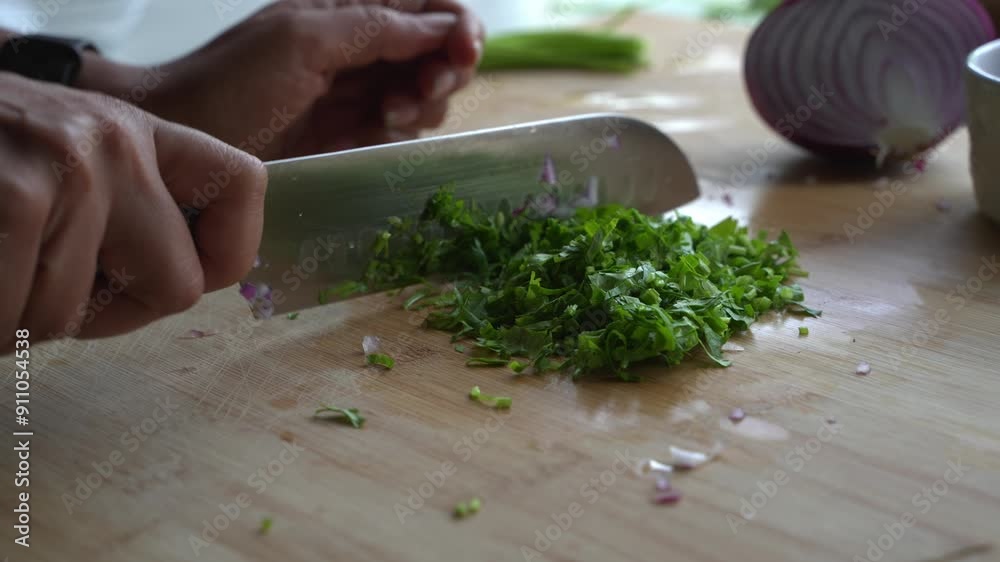 Chopping bunch of cilantro leaves into small pieces for garnish and flavor special ingredients to cook a meal two cans of beans rice plantain avocado red Chopping bunch of cilantro leaves into small pieces for garnish and flavor special ingredients to cook a meal two cans of beans rice plantain avocado red