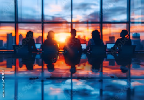 Silhouettes of Businesspeople Working in Office with City Sunset View