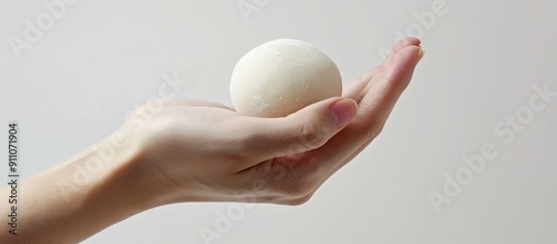 Isolated hand holding a mochi or moci wijen with copy space image available photo