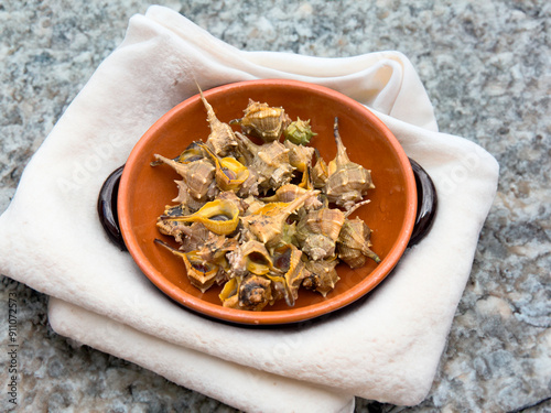 Bolinus brandaris or murici, Plate of seafood morsels with lemon, boiled sea snails, Mediterranean Food photo
