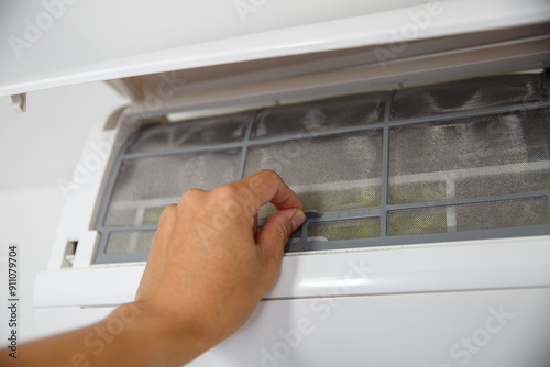 Photography hand  at a very dirty air-conditioner filter that needs cleaning