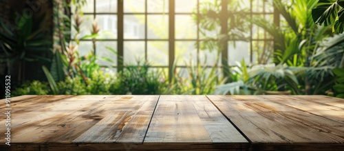 A vacant wooden tabletop with a blurred window showcasing a lovely garden view providing room for product advertising with a captivating window garden as the backdrop for the copy space image