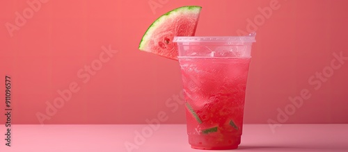 Refreshing watermelon drink in a plastic cup with a slice of watermelon on top ideal for a copy space image photo