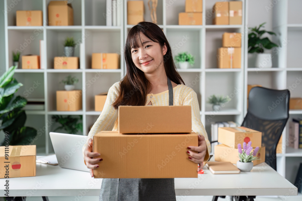 Young Woman Entrepreneur Holding Boxes in Modern Home Office for Online Business Startup Young Woman Entrepreneur Holding Boxes in Modern Home Office for Online Business Startup