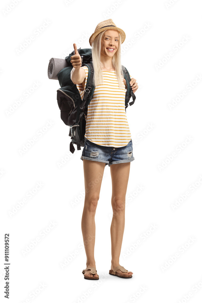 Happy female tourist with a backpack gesturing thumbs up Happy female tourist with a backpack gesturing thumbs up