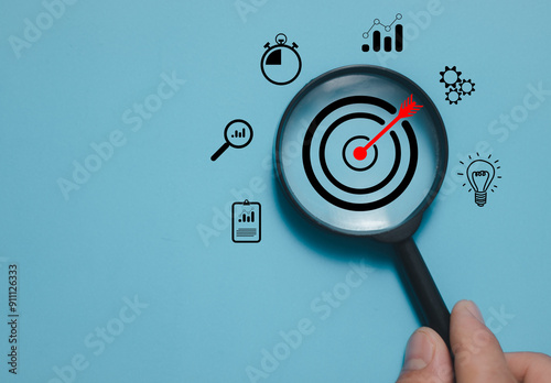 Magnifier glass focus on target dartboard, Business development strategy, and action plan concept with icon business strategy and Action plan, search, goal, strategy, success.