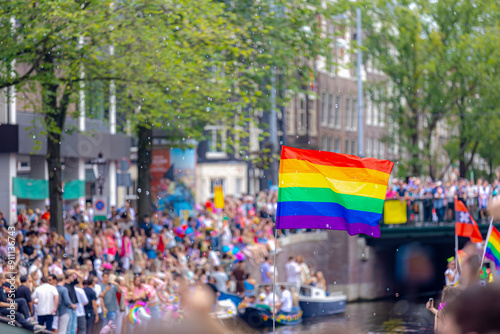 Foto Amsterdam canal parade, Decoration with colourful rainbow flags along canals and street, LGBTQ community, Annual festival to celebrate in August, One of the greatest events in the world, Netherlands