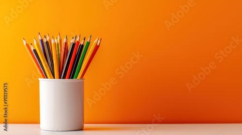 Education banner on an orange background, back to school theme, stationery cup with colored pencils, notebook, and textbooks, copy space