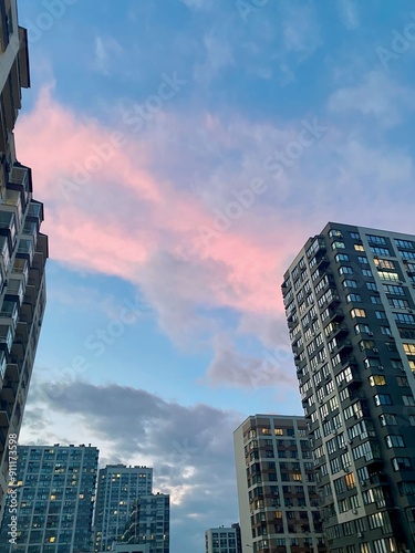 Beautiful pink sunset in the city among skyscrapers