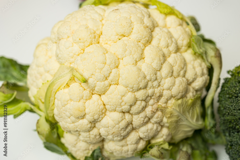 Fresh cauliflower on a white background, close-up, selective focus Fresh cauliflower on a white background, close-up, selective focus