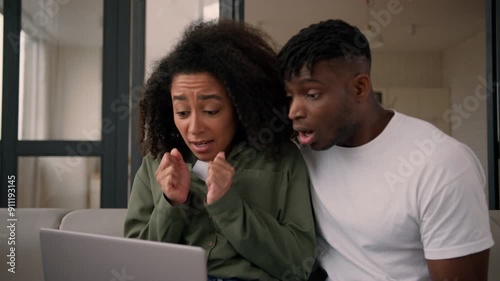 African American couple woman man female male girlfriend boyfriend hope wish expect result looking at laptop computer screen receive email bad news upset sad disappointed problem fail credit at home