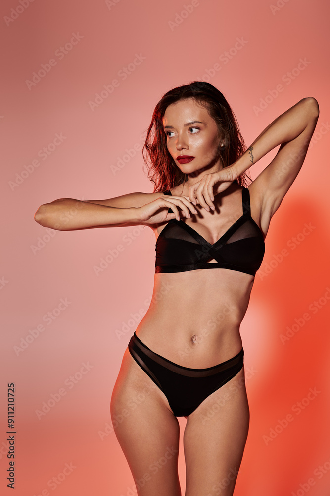 A young woman poses artfully, showcasing confidence in elegant lingerie.