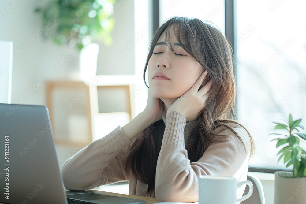 young japanese woman feeling stressed while working at home young japanese woman feeling stressed while working at home