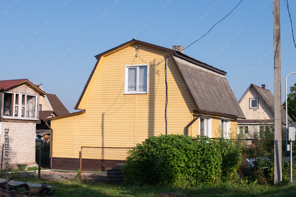 Yellow Wooden House with Greenery in a Suburban Neighborhood Yellow Wooden House with Greenery in a Suburban Neighborhood