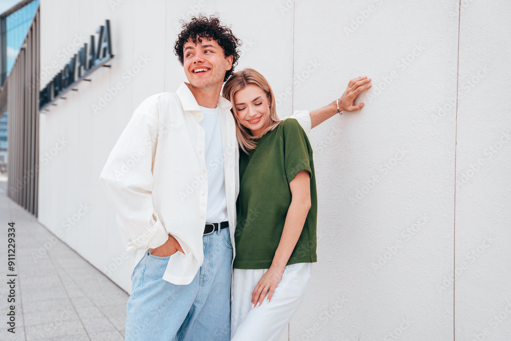 Smiling beautiful woman and her handsome boyfriend. Couple in casual summer clothes. Happy cheerful family. Female and man having fun. They posing in the street in sunny day. Having tender moments Smiling beautiful woman and her handsome boyfriend. Couple in casual summer clothes. Happy cheerful family. Female and man having fun. They posing in the street in sunny day. Having tender moments