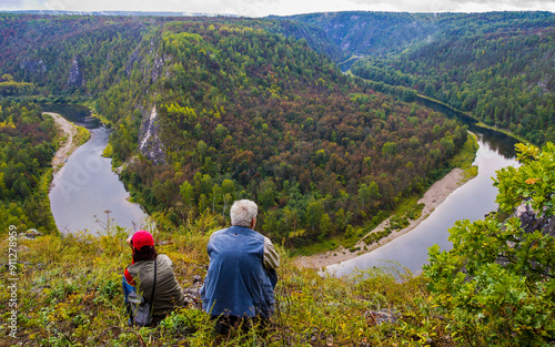 beautiful mature couple at the edge of the beautiful white river in the southern Urals