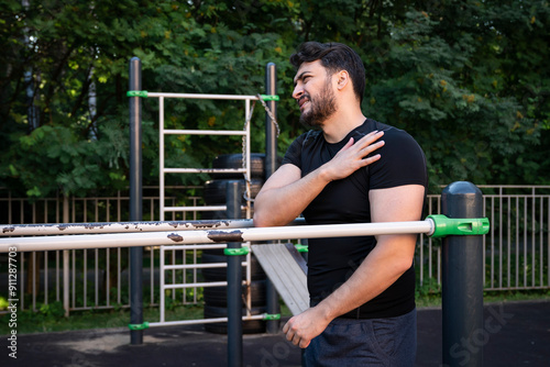 An athlete suffering from severe shoulder pain injured his joint while training on the parallel bars	