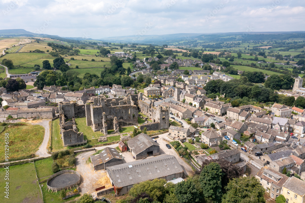 Aerial drone photo of the beautiful town of Middleham in Leyburn in North Yorkshire in the UK showing the British countryside town and the historic Middleham Castle on a sunny day in the summer time