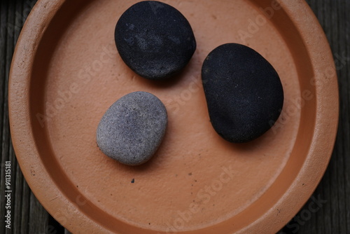 Photography natural stones on a fuzz peach ceramic plant coaster
