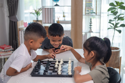 Two children playing a game of chess. One is a boy and the other is a girl. They are sitting at a table with a chess board in front of them