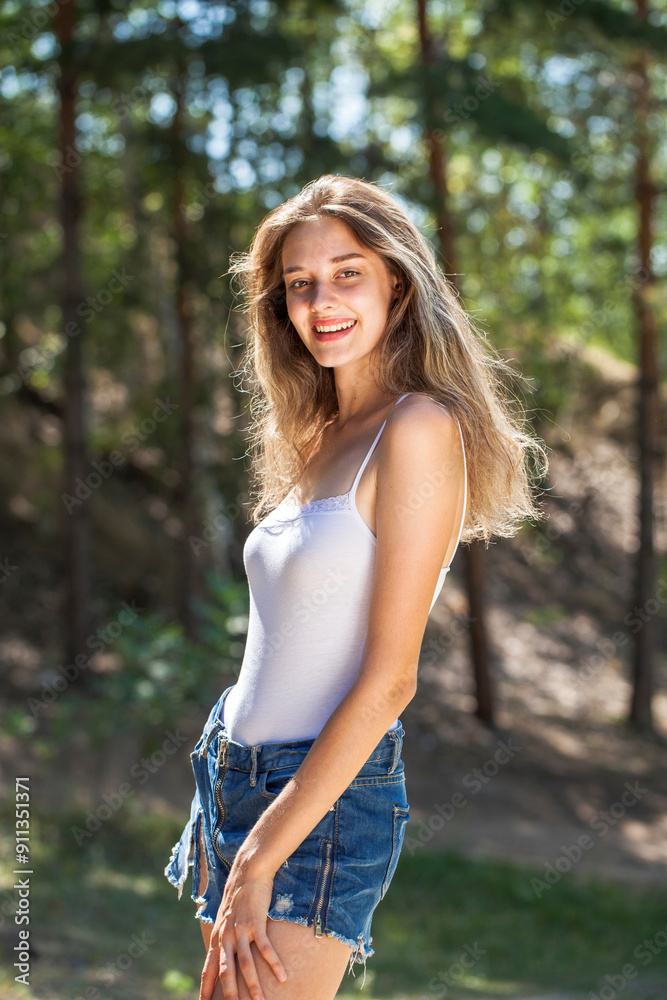 Portrait of a young beautiful woman posing in the forest Portrait of a young beautiful woman posing in the forest