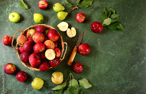 Fototapeta Naklejka Na Ścianę i Meble -  Apples in basket on sunny concrete table, thanksgiving background, harvest, healthy natural food concept, detox diet and body cleansing, banner on screen, cafe,