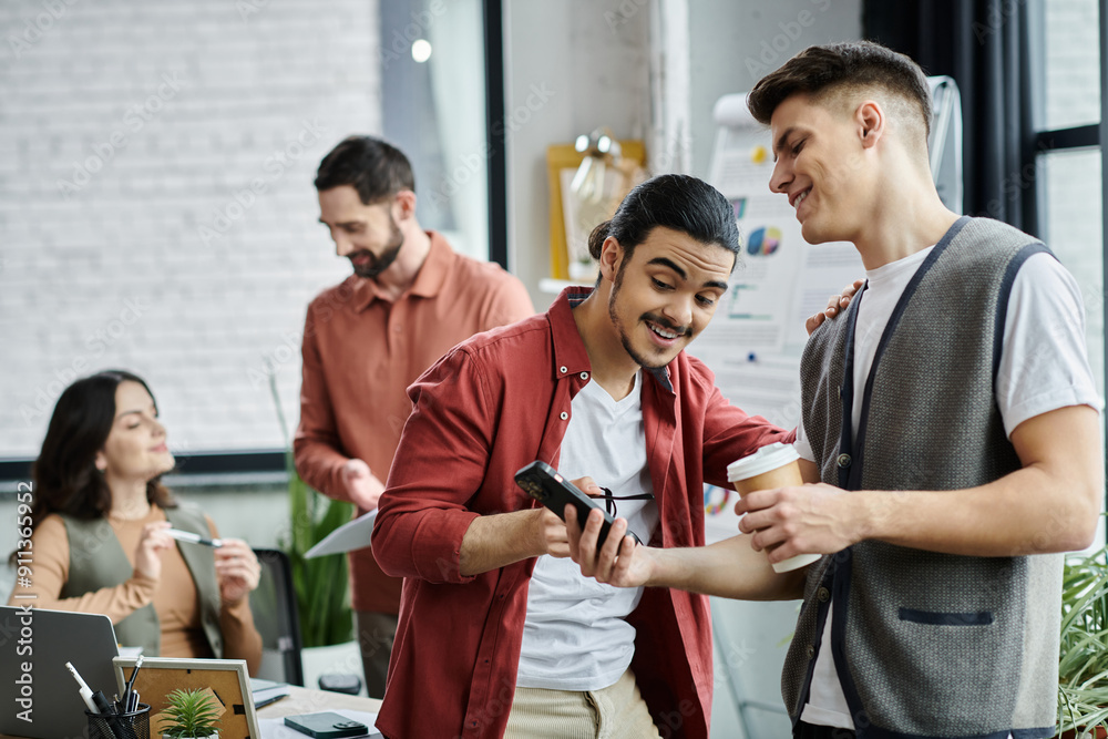 © LIGHTFIELD STUDIOS - Colleagues engage in casual conversation while in office.