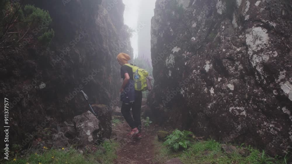 girl hiking alone in fog in the mountains girl hiking alone in fog in the mountains
