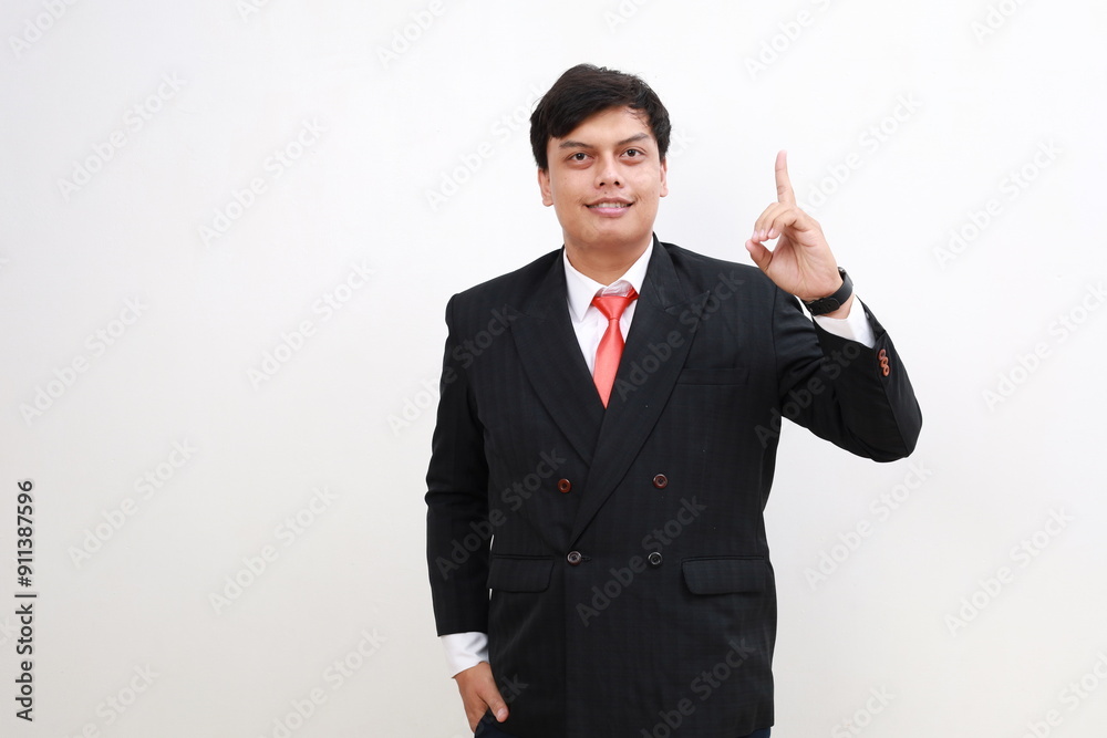 Young and handsome Asian businessman in a suit showing number one hand gestures. Young and handsome Asian businessman in a suit showing number one hand gestures.
